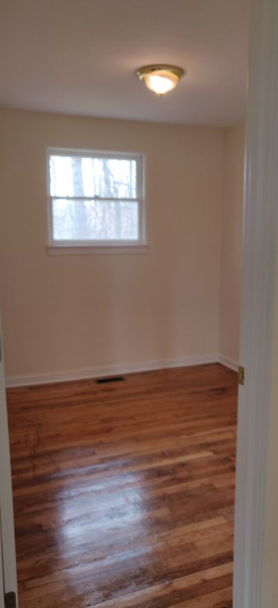 Bedroom with window and hardwood floor
