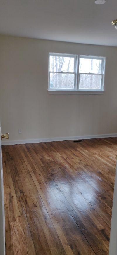 Bedroom with hardwood floor and window