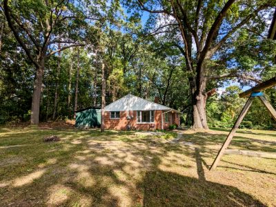 The house across the wooded front lot