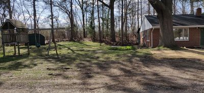 Panorama of the side yard, storage shed and the back of the house