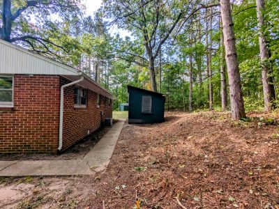 Brick side elevation with one of the two storage sheds