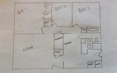 Floor plan sketch showing three bedrooms, living room, kitchen and dining area
