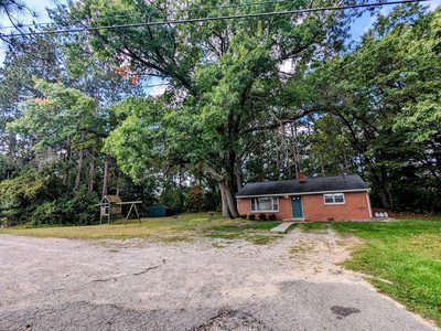 Front of the brick ranch seen from the driveway
