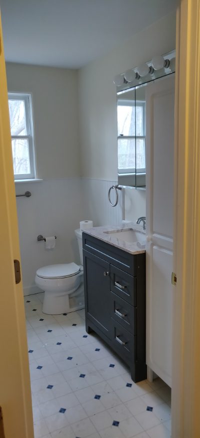 Full bathroom with vanity and toilet